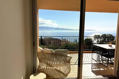 a room with a balcony with a view of the ocean at Bright studio with sea view in Ajaccio in Ajaccio