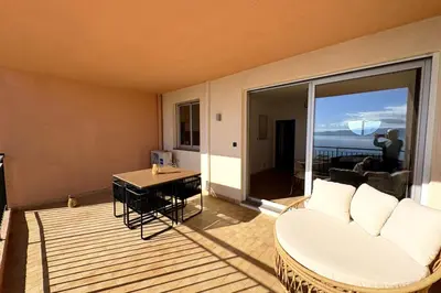 a living room with a couch and a table at Bright studio with sea view in Ajaccio in Ajaccio