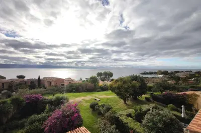 a view of a garden with a view of the water at Bright studio with sea view in Ajaccio in Ajaccio