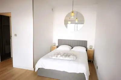 a bedroom with a white bed and a mirror at Bright studio with sea view in Ajaccio in Ajaccio