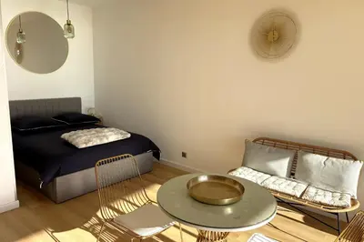 a bedroom with a bed and a table and a chair at Bright studio with sea view in Ajaccio in Ajaccio