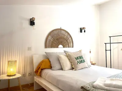a white bedroom with a bed with pillows at Charmant Duplex à la campagne in Riventosa