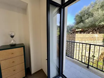 a room with a glass door leading to a balcony at Magnifique T3 tout confort in Propriano