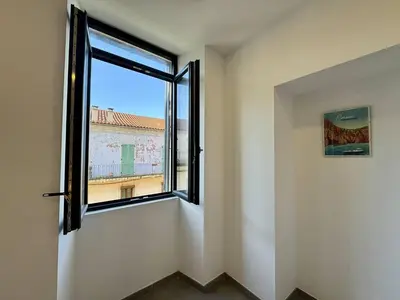 an empty room with a window with a view at Magnifique T3 tout confort in Propriano