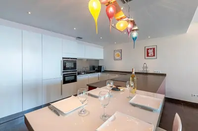 a kitchen with a table with wine glasses and balloons at Strada Agosta - Terrasse vue mer in Albitreccia