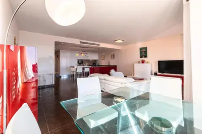 a living room with a glass table at Strada Agosta - Terrasse vue mer in Albitreccia