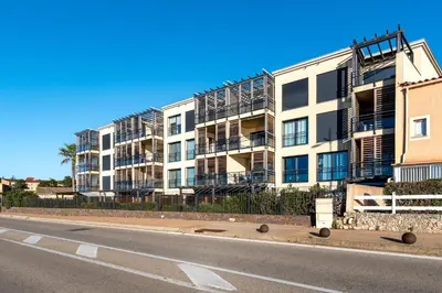 an empty street in front of an apartment building at Strada Agosta - Terrasse vue mer in Albitreccia