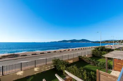 a view of the beach from the balcony of a building at Strada Agosta - Terrasse vue mer in Albitreccia