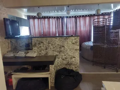 a room with a bed and a desk with a television at AJACCIO GRAND STUDIO LOFT VUE MER ET MONTAGNE 5 p in Ajaccio