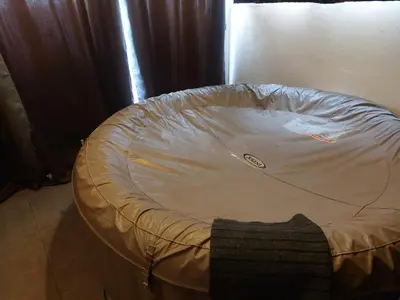 a round bed with a white sheet on the floor at AJACCIO GRAND STUDIO LOFT VUE MER ET MONTAGNE 5 p in Ajaccio