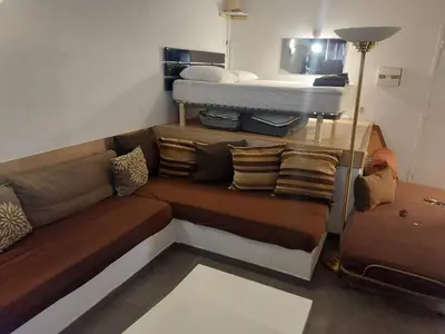 a living room with a couch and a bed at AJACCIO GRAND STUDIO LOFT VUE MER ET MONTAGNE 5 p in Ajaccio