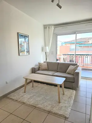 a living room with a couch and a coffee table at Appartement Cosy Port de Porto-Vecchio in Porto-Vecchio