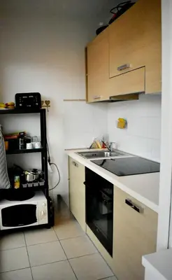 a small kitchen with a sink and a microwave at Appartement Cosy Port de Porto-Vecchio in Porto-Vecchio