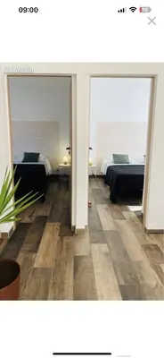 a room with two beds and two mirrors at Villa Marilou avec petite piscine privée in Figari