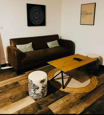 a living room with a couch and a coffee table at Villa Carmen avec petite piscine privée in Figari