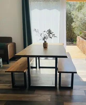 a coffee table and benches in a living room at Villa Carmen avec petite piscine privée in Figari