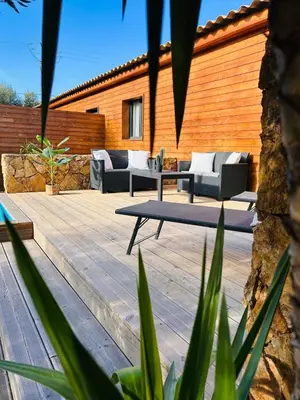 a patio with couches on a wooden deck at Villa Carmen avec petite piscine privée in Figari