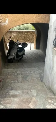 a motorcycle parked in a tunnel under a bridge at Zilia in Zilia