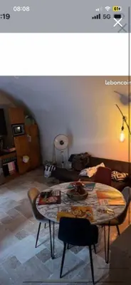 a living room with a table and a couch at Zilia in Zilia