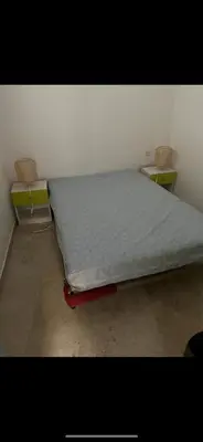 a bed sitting in a room with two chairs at Zilia in Zilia