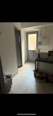 a room with a hallway with a door and a table at Zilia in Zilia