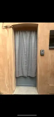a garage door with a window and a curtain at Zilia in Zilia