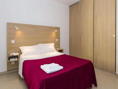 a bedroom with a large bed with a red blanket at Sea-view holiday home in Solenzara in Kamiesch