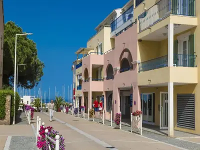 a pink building with flowers in front of it at Sea-view holiday home in Solenzara in Kamiesch