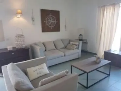 a living room with a couch and a table at Sea-view holiday home in Solenzara in Kamiesch