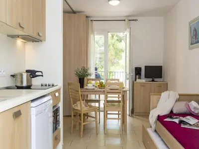 a kitchen and dining room with a table and chairs at Sea-view holiday home in Solenzara in Kamiesch