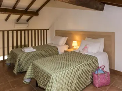 two beds with a teddy bear sitting on top of them at Gorgeous apartment for 4 people with balcony in Linguizzetta