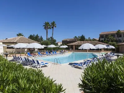a swimming pool with lounge chairs and umbrellas at Gorgeous apartment for 4 people with balcony in Linguizzetta