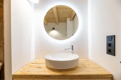 a bathroom with a white sink and a mirror at Maison Lucciana - Santa Giulia in Porto-Vecchio