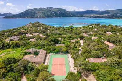 an aerial view of a tennis court and the ocean at Maison Lucciana - Santa Giulia in Porto-Vecchio