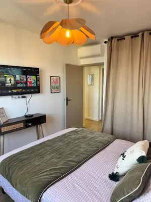 a bedroom with a bed with a flat screen tv at Nouveau ! Sublime T2 Ajaccio in Ajaccio