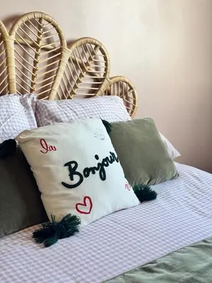 a bed with a pillow with the word sonbourg on it at Nouveau ! Sublime T2 Ajaccio in Ajaccio