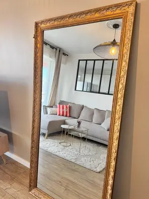 a mirror reflecting a living room with a couch at Nouveau ! Sublime T2 Ajaccio in Ajaccio
