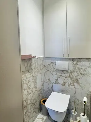 a bathroom with a toilet and a white cabinet at Nouveau ! Sublime T2 Ajaccio in Ajaccio