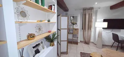 a living room with a staircase and a living room with a table at Studio en centre ville a 2 minutes de la plage in Ajaccio