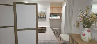 a living room with a couch and a table and a mirror at Studio en centre ville a 2 minutes de la plage in Ajaccio