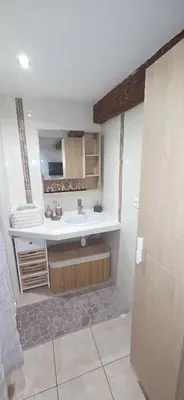 a bathroom with a sink and a mirror at Studio en centre ville a 2 minutes de la plage in Ajaccio