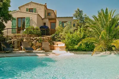 a house with a swimming pool in front of a house at Casa with pool near Palombaggia in Porto-Vecchio