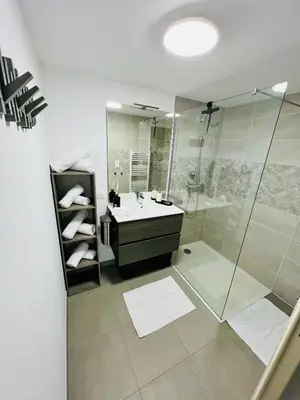 a bathroom with a sink and a shower at Alivu Immurtale - T3 design standing & confort, terrasse XXL in Propriano