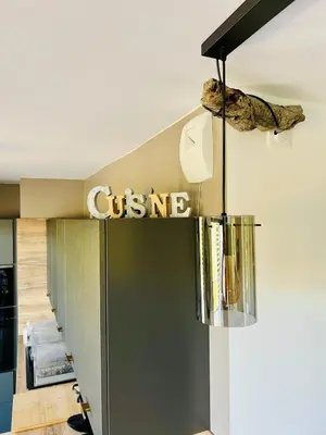 a chandelier hangs from the ceiling of a store at Alivu Immurtale - T3 design standing & confort, terrasse XXL in Propriano