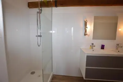 a white bathroom with a shower and a sink at Villa la Chiosella in Valle-di-Mezzana