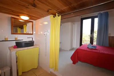 a kitchen with a sink and a bed in a room at Villa la Chiosella in Valle-di-Mezzana