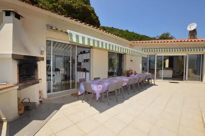 a group of tables and chairs on a patio at Villa la Chiosella in Valle-di-Mezzana