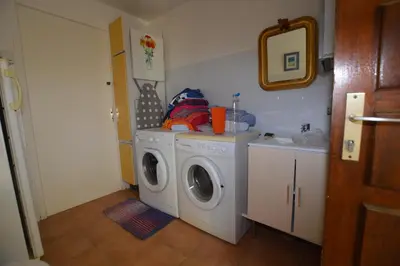 a laundry room with a washing machine and a washer at Villa la Chiosella in Valle-di-Mezzana