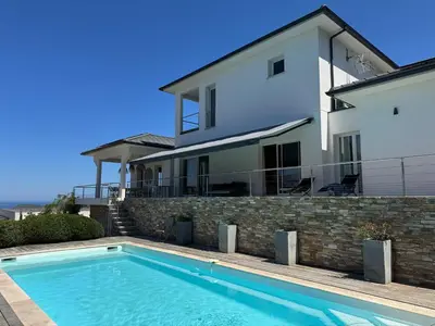 a house with a swimming pool in front of a house at Villa Oletta, Saint Florent in Oletta