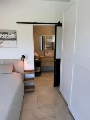 a living room with a couch and a bedroom at Villa Oletta, Saint Florent in Oletta